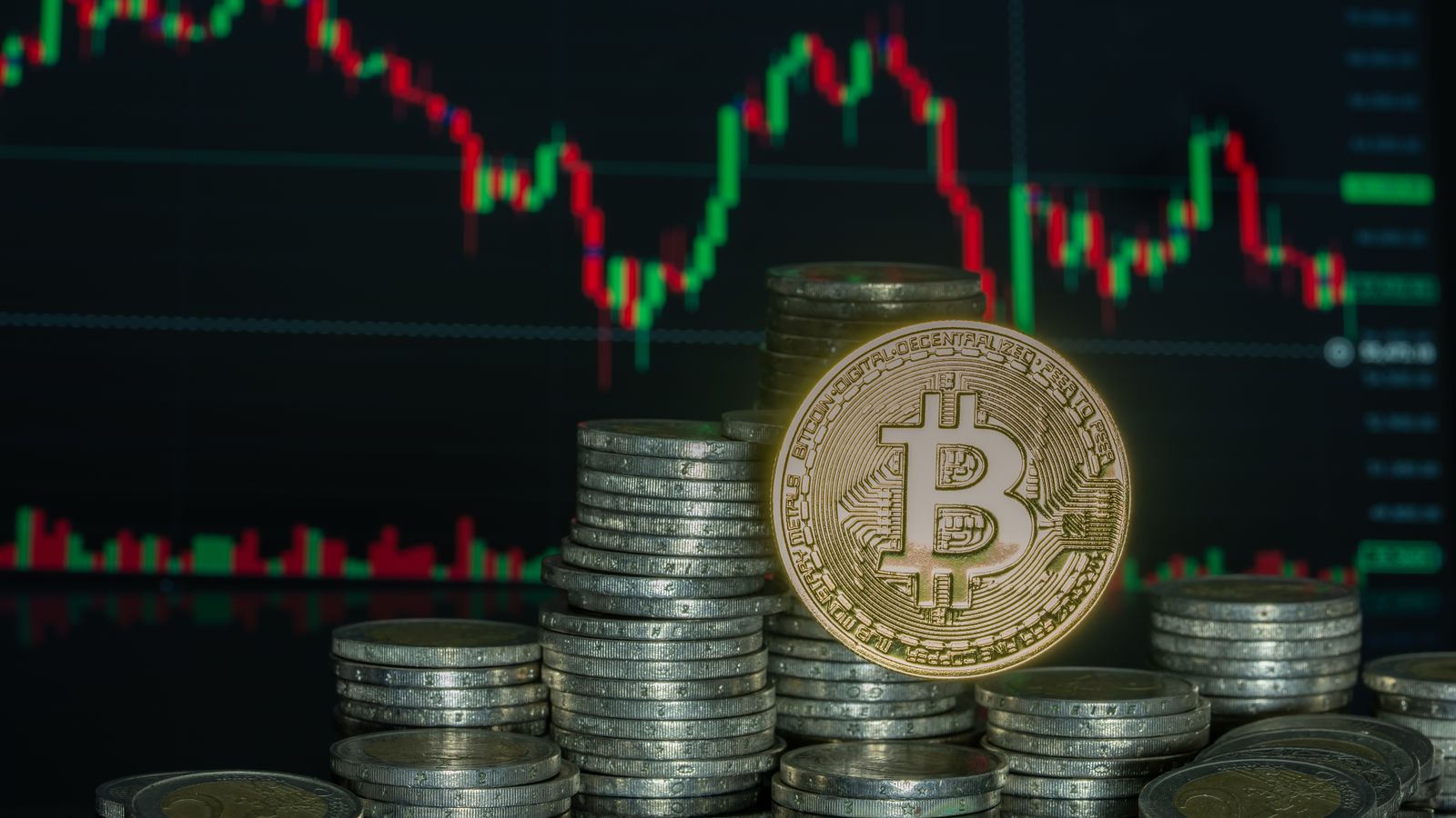 Pièces de monnaie numériques empilées devant un écran de cours, illustrant les obligations AML des émetteurs de stablecoins en Belgique